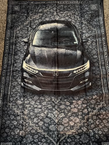 Black sedan rug with detailed patterned border