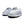 A close-up of a pair of unisex slippers featuring soft premium faux fur and local cotton. The rubber dot sole is clearly visible, emphasizing durability and grip. The slippers are displayed on a cozy rug.