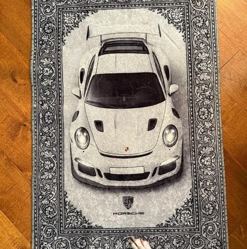 White sports car rug displayed on a wooden floor